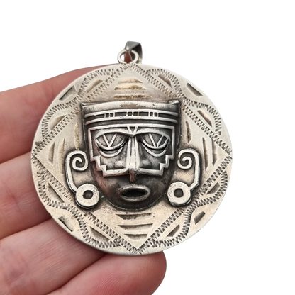 Reversible .925 sterling silver Aztec calendar and mask pendant, Mexico, 1960s-70s