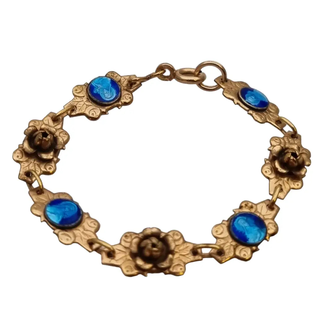 Pulsera religiosa antigua dorada para niña con medallas de esmalte azul.