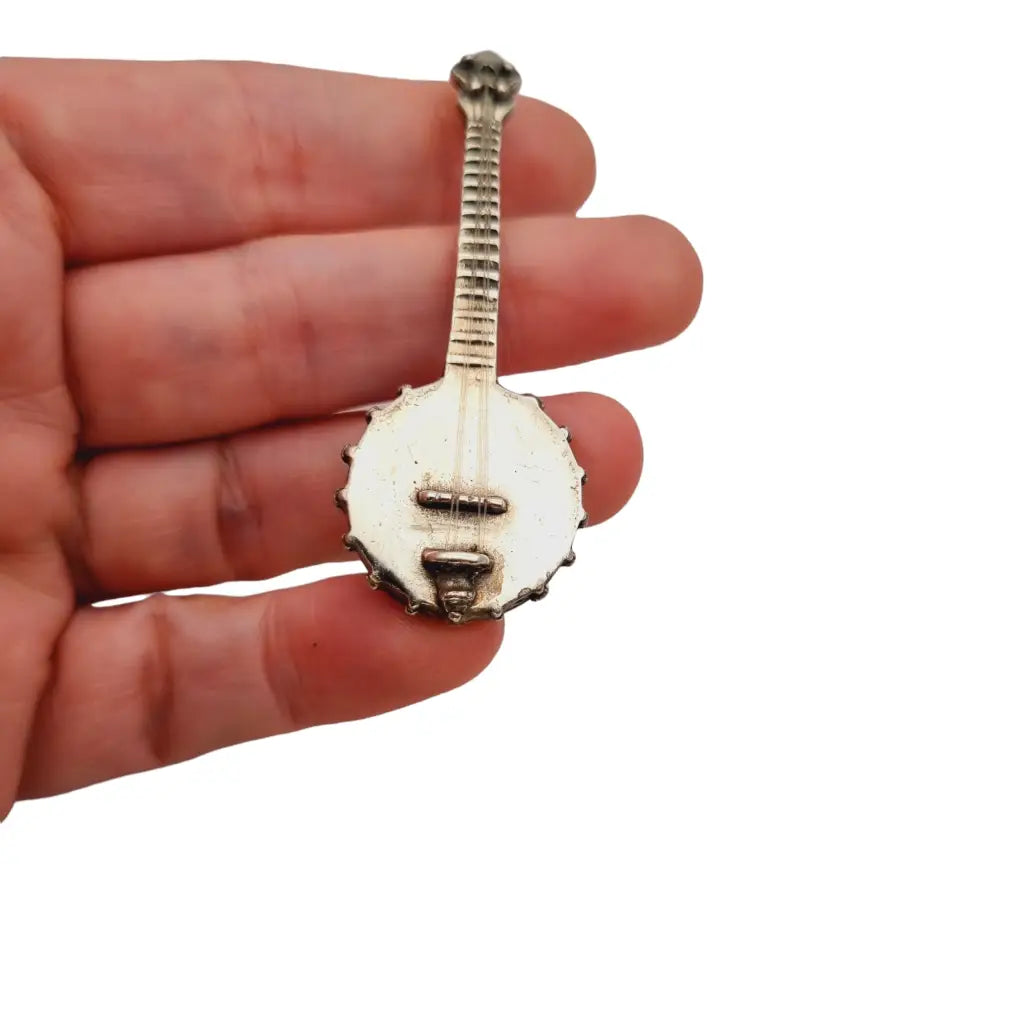 Figura banjo miniatura de plata ley instrumento musical para coleccionar.