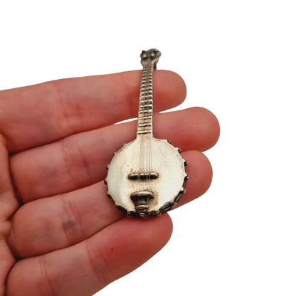 Figura banjo miniatura de plata ley instrumento musical para coleccionar.