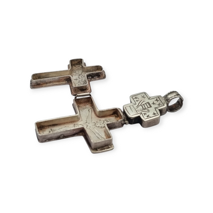 Antique Byzantine-style silver reliquary cross with engraved religious scenes.