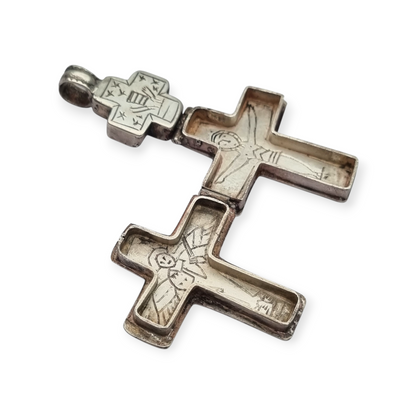 Antique Byzantine-style silver reliquary cross with engraved religious scenes.