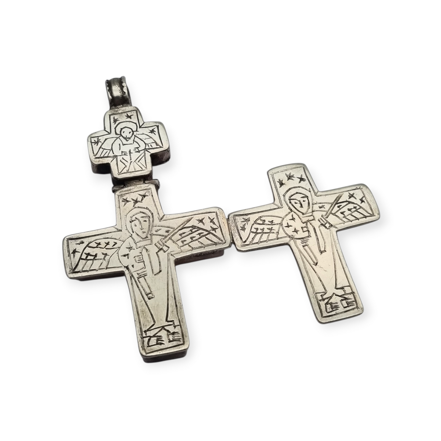 Antique Byzantine-style silver reliquary cross with engraved religious scenes.