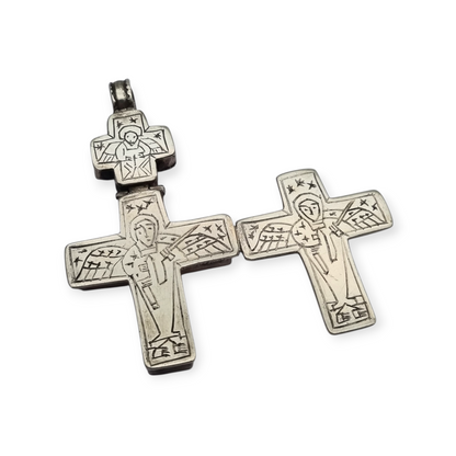 Antique Byzantine-style silver reliquary cross with engraved religious scenes.