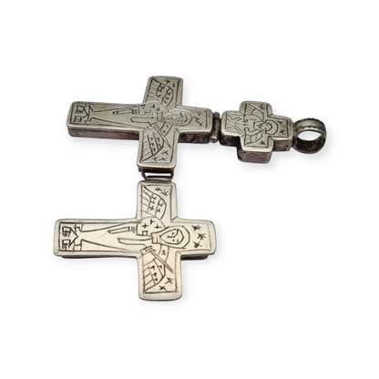 Antique Byzantine-style silver reliquary cross with engraved religious scenes.