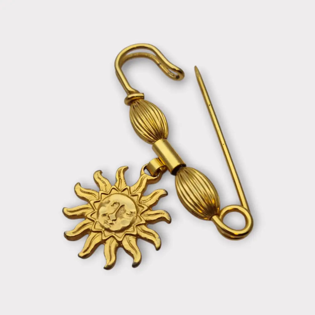 Broche y alfiler de seguridad vintage bañado en oro con colgante cara sol