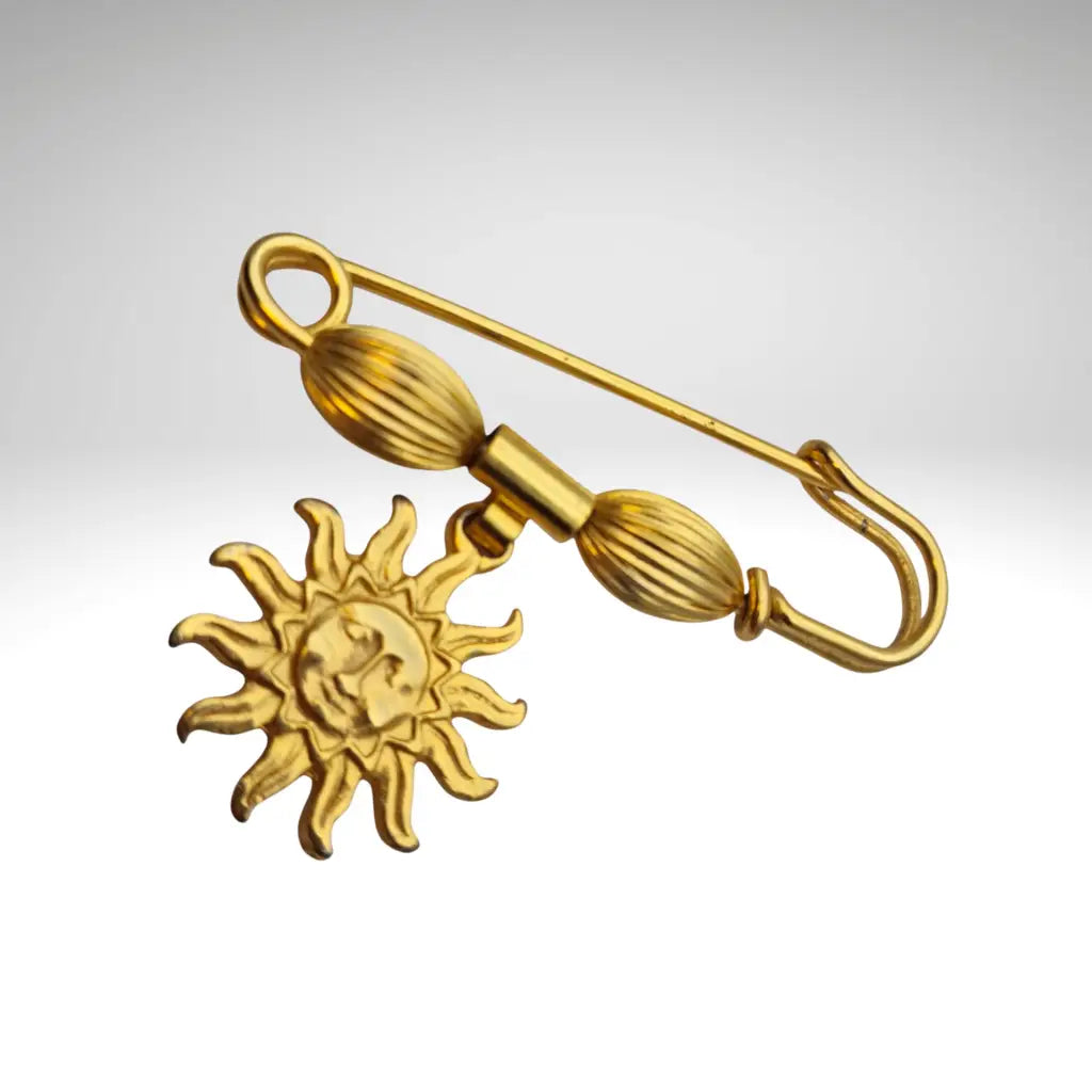 Broche y alfiler de seguridad vintage bañado en oro con colgante cara sol