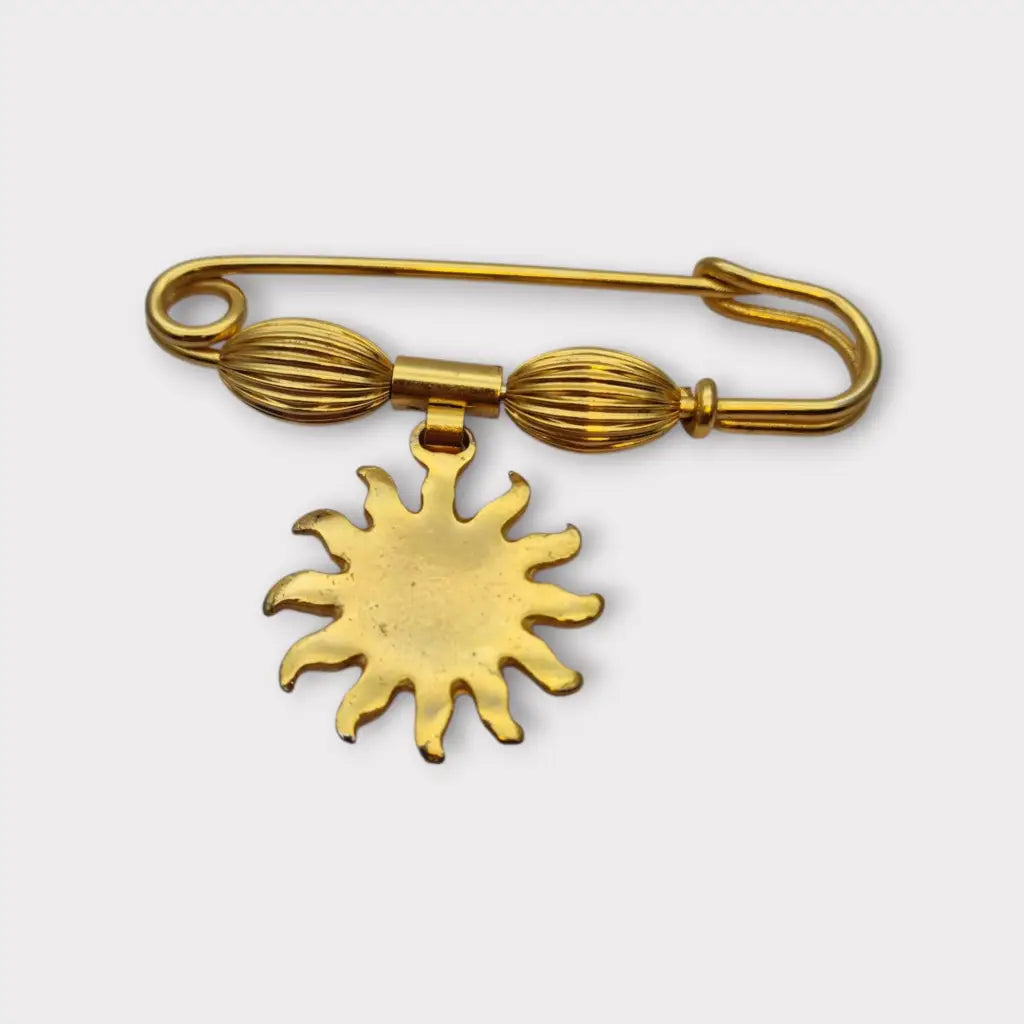 Broche y alfiler de seguridad vintage bañado en oro con colgante cara sol