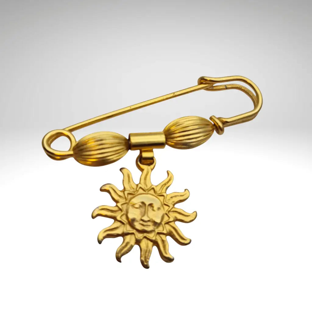 Broche y alfiler de seguridad vintage bañado en oro con colgante cara sol