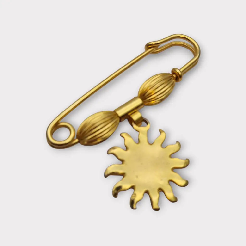 Broche y alfiler de seguridad vintage bañado en oro con colgante cara sol