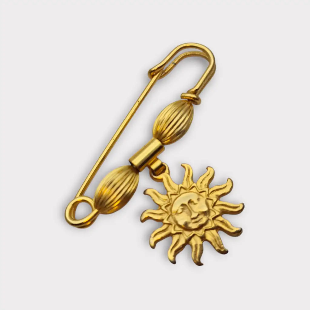 Broche y alfiler de seguridad vintage bañado en oro con colgante cara sol