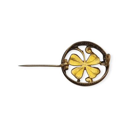 Broche antiguo Art Nouveau en metal dorado flor calada con cristal rojo central