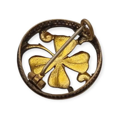 Broche antiguo Art Nouveau en metal dorado flor calada con cristal rojo central