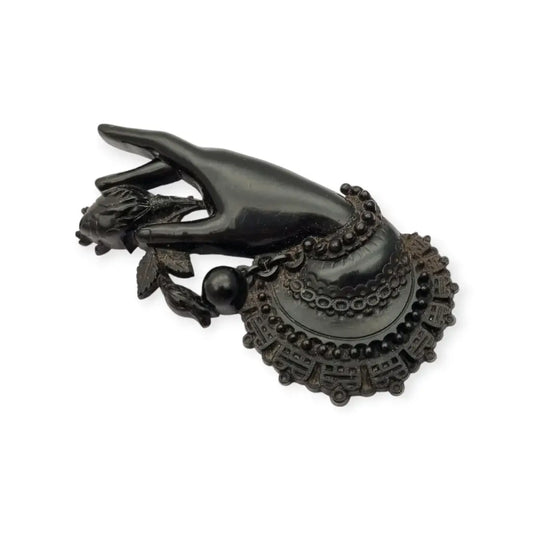 Broche antiguo victoriano en forma de mano sosteniendo flor vulcanita joya