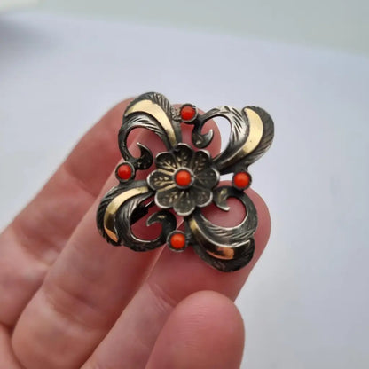 Broche Art Decó en plata con piedra roja y diseño floral detalles dorados