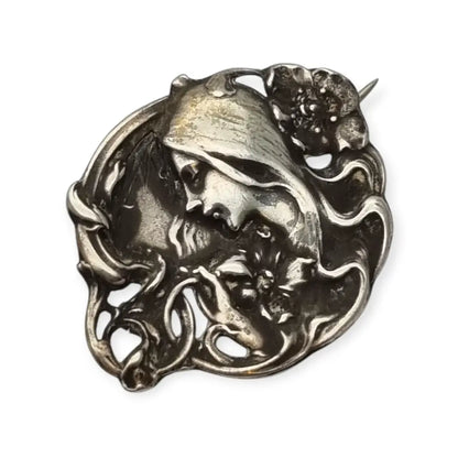 Broche Art Nouveau con mujer y flores en relieve diseño de líneas sinuosas