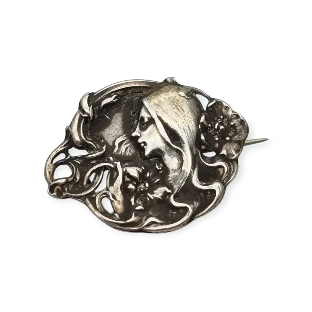 Broche Art Nouveau con mujer y flores en relieve diseño de líneas sinuosas