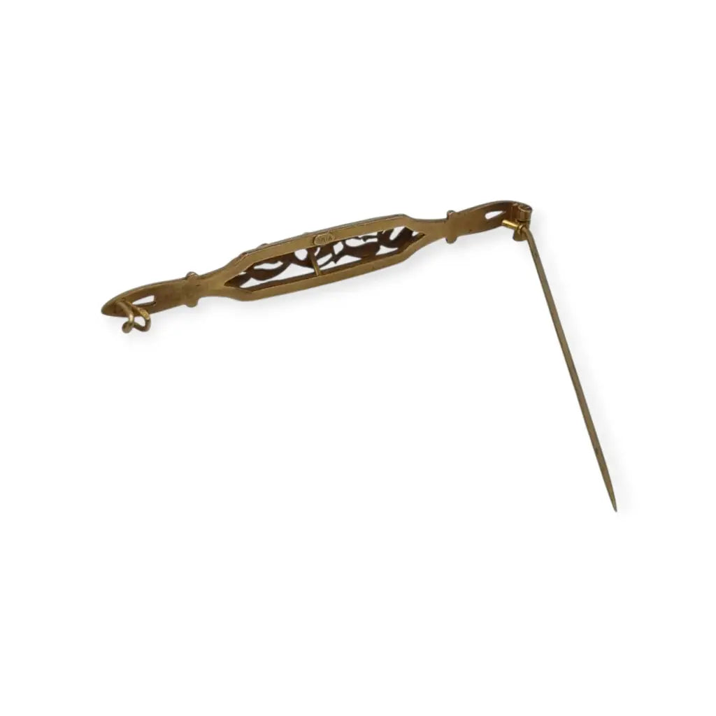 Broche Art Nouveau de Oria en oro laminado con flor calada y cristal rojo Circa