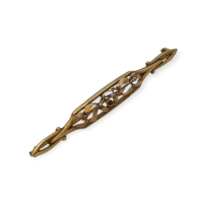 Broche Art Nouveau de Oria en oro laminado con flor calada y cristal rojo Circa