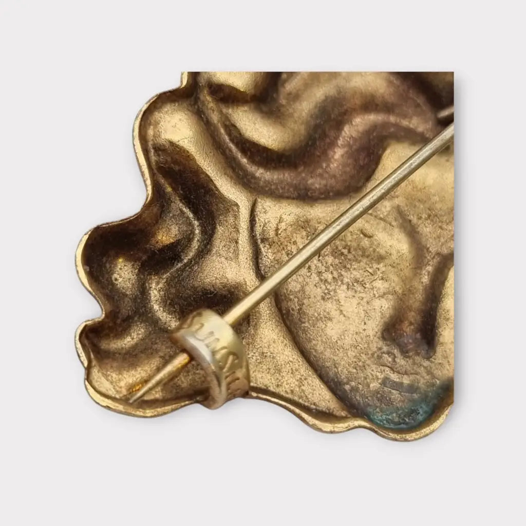 Broche de cabeza contemporáneo marca sunsilk en latón dorado. Bisutería