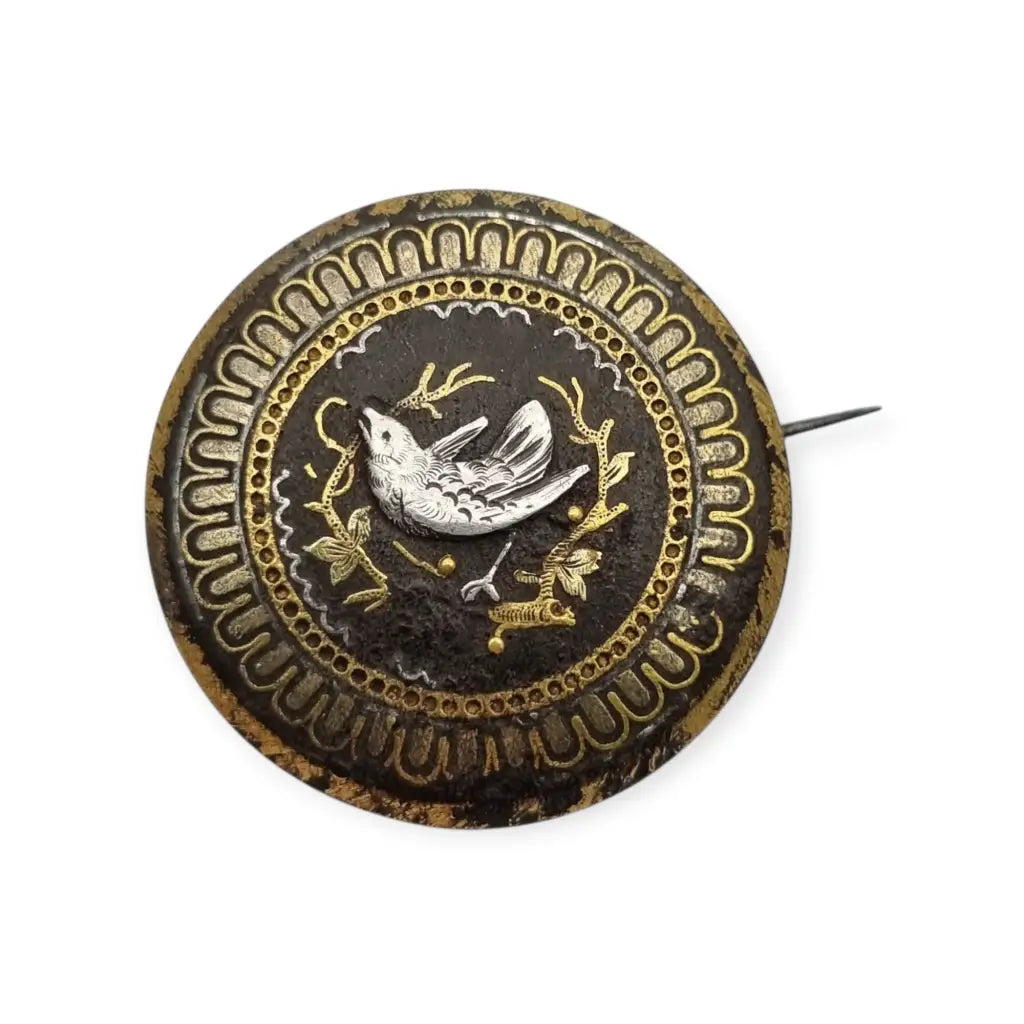 Broche damasquinado oro de Toledo con motivo pájaro grabado años 1920.
