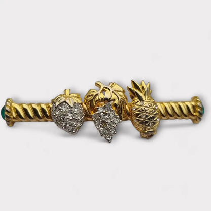 Broche de fruta con diamantes imitación dorados pinchos verdes