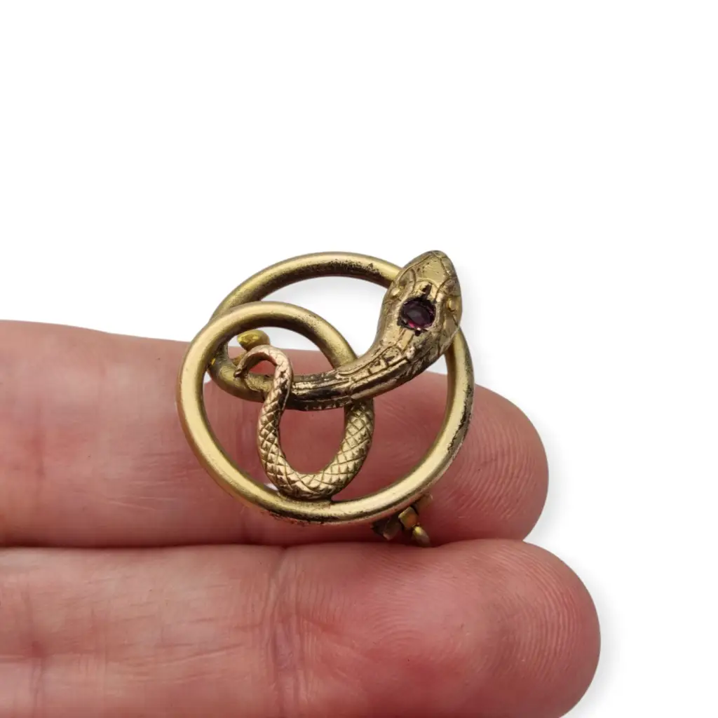 Broche victoriano antiguo en metal dorado con serpiente entrelazada y ojo