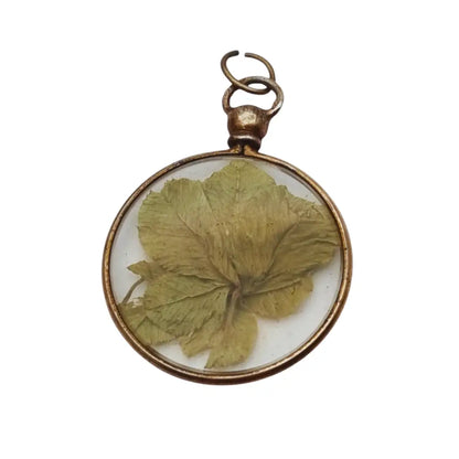 Colgante Guardapelo para fotos antiguo con flor natural seca bajo cristal 1940.