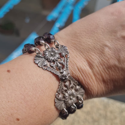 Antique silver modernist bracelet, floral motif and garnet glass beads.